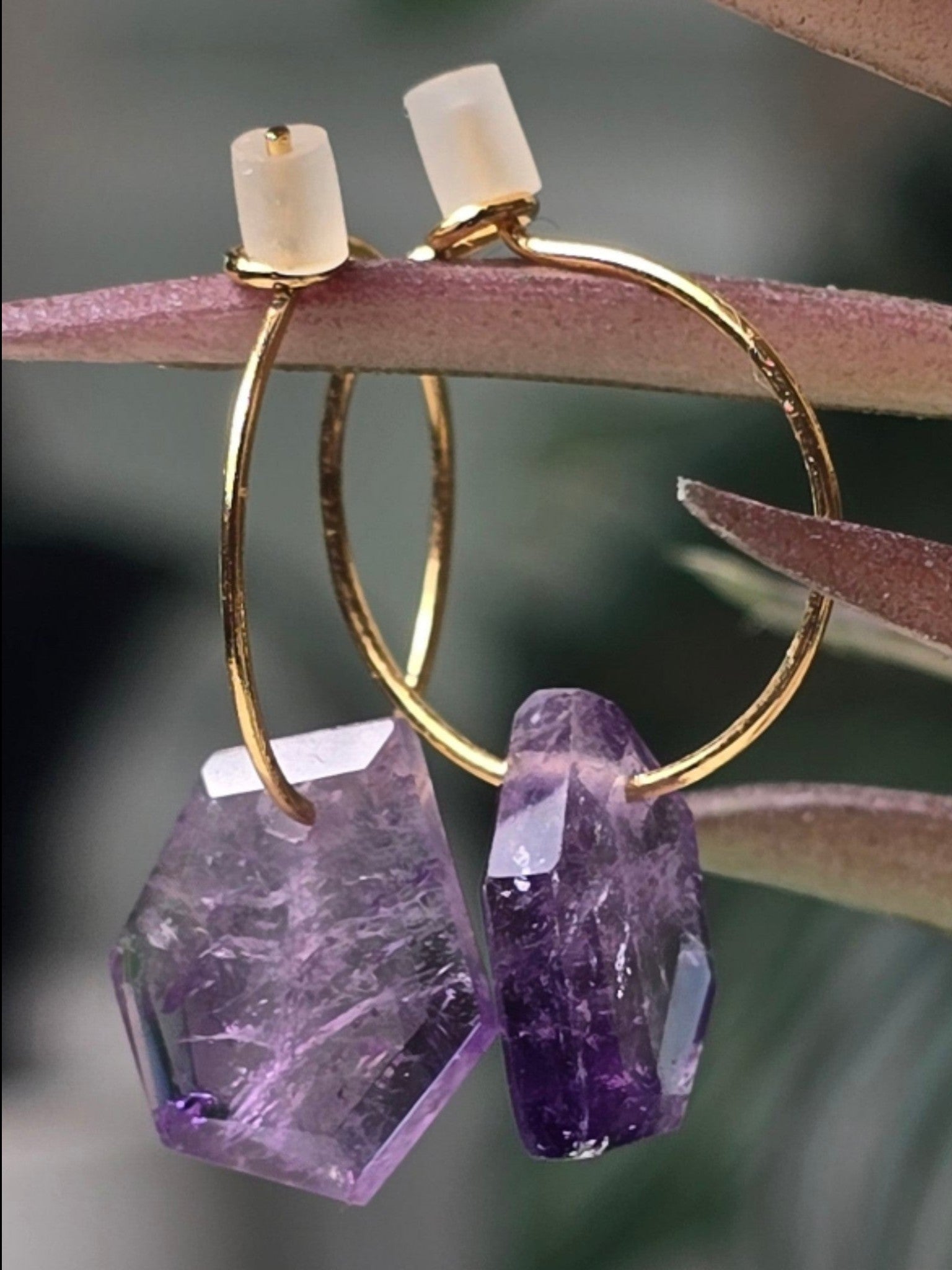 reveriebygemma Lucid Drops amethyst hoop earrings featuring faceted purple gemstones on 14kt gold plated hoops.