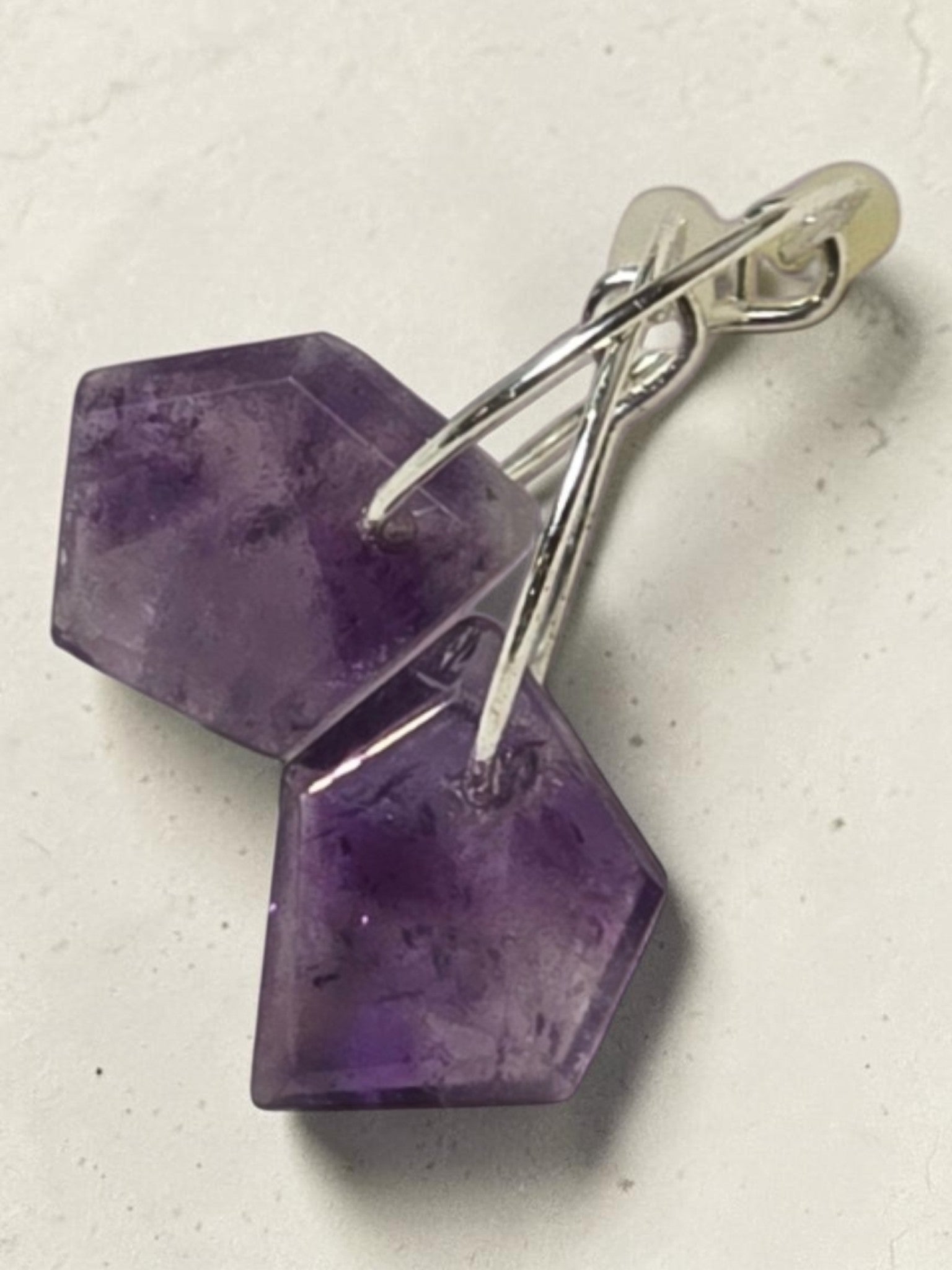 reveriebygemma Lucid Drops amethyst huggie earrings featuring faceted purple gemstones on 14kt gold plated hoops.