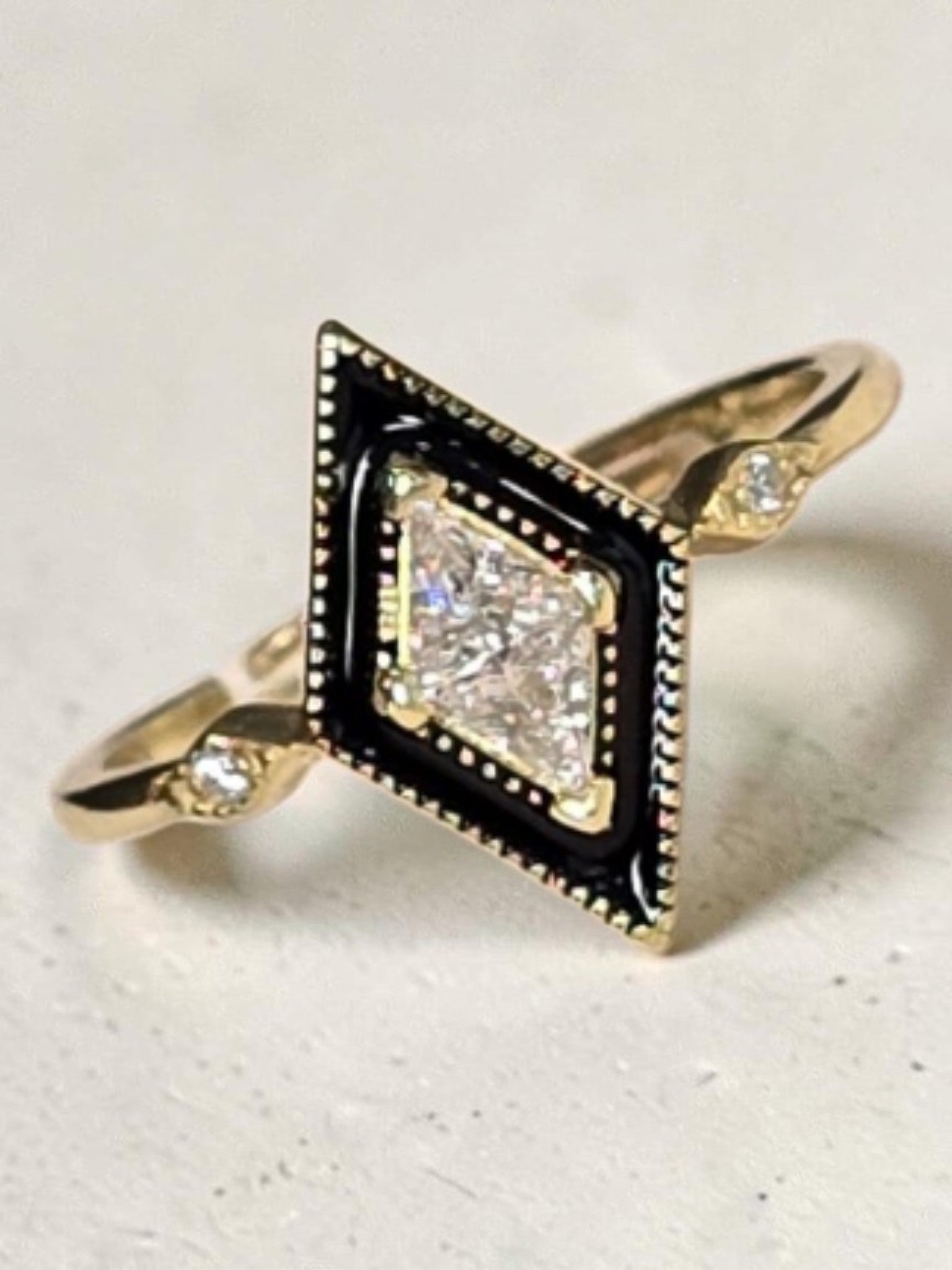 reveriebygemma gold plated sterling silver ring with a black enamel rhombus signet face and cubic zirconia stones