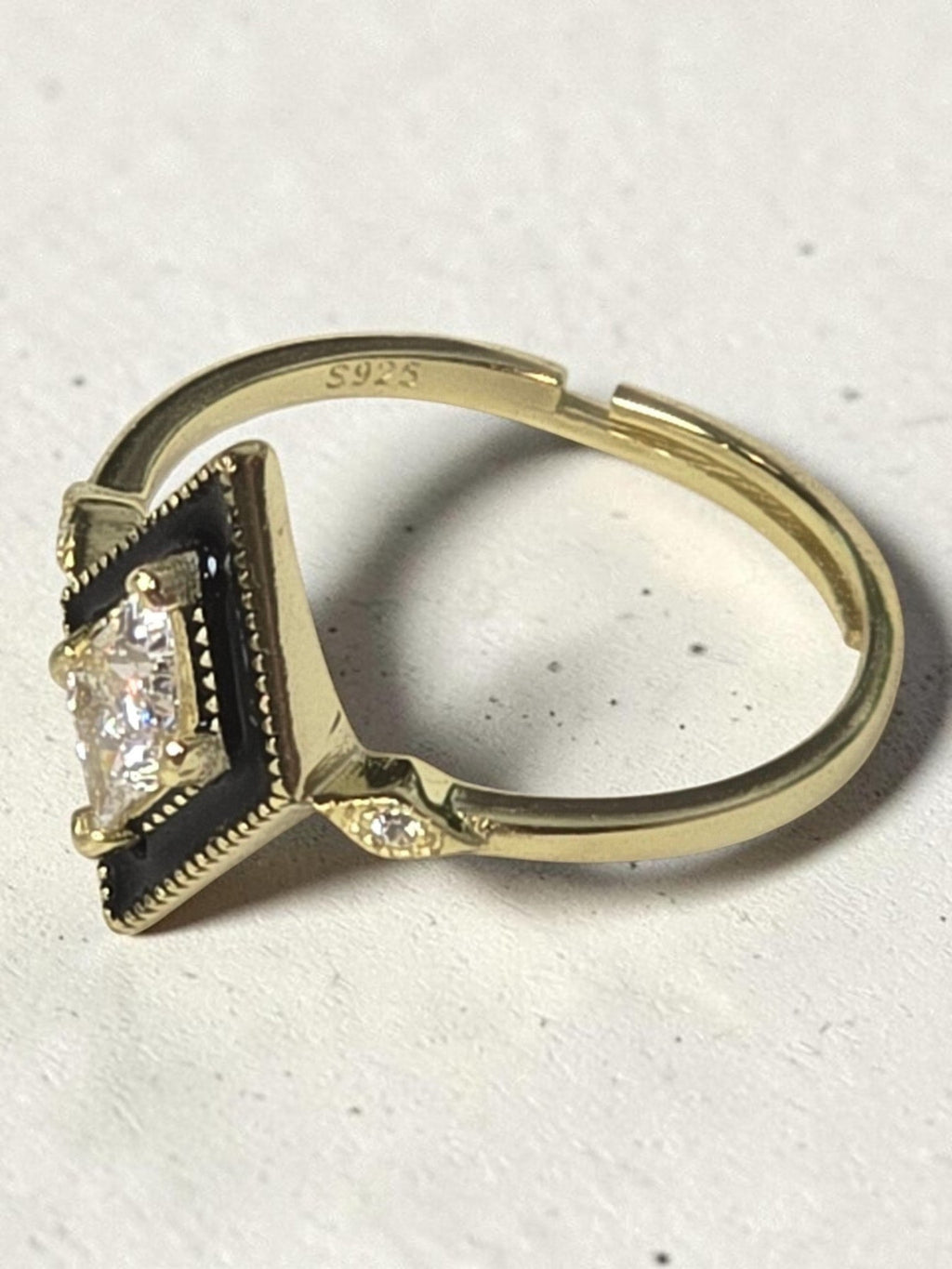 reveriebygemma gold plated sterling silver signet ring with black enamel, rhombus shape, and cubic zirconia stone.