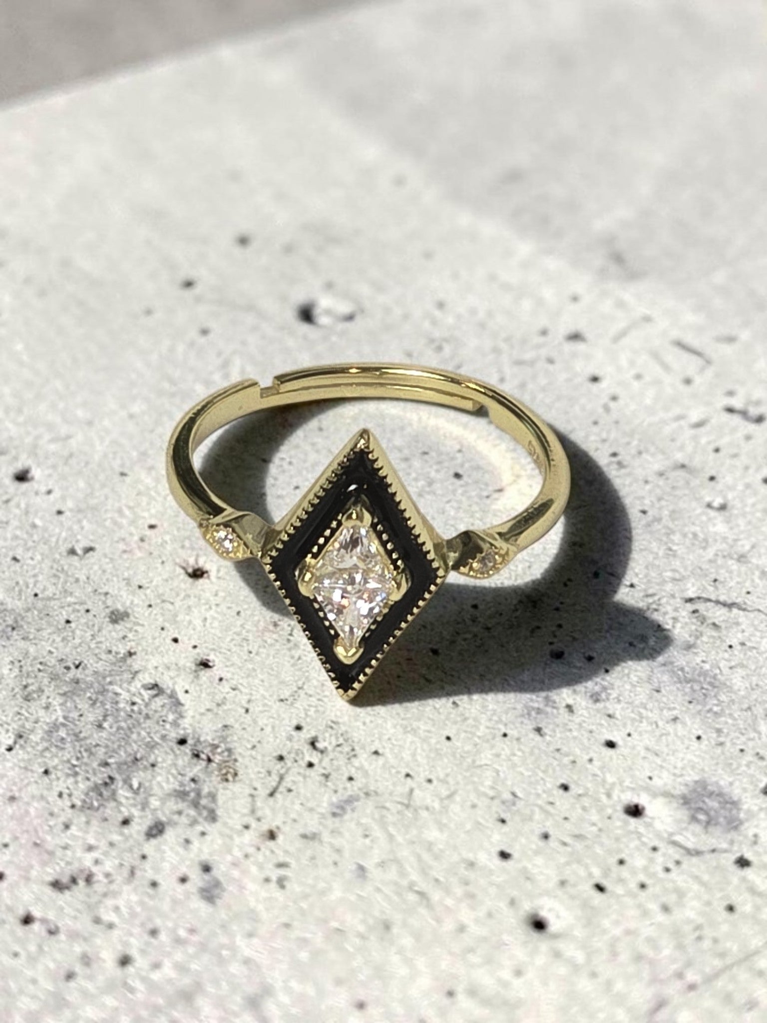 reveriebygemma gold plated sterling silver signet ring with a black enamel rhombus face and cubic zirconia stone.