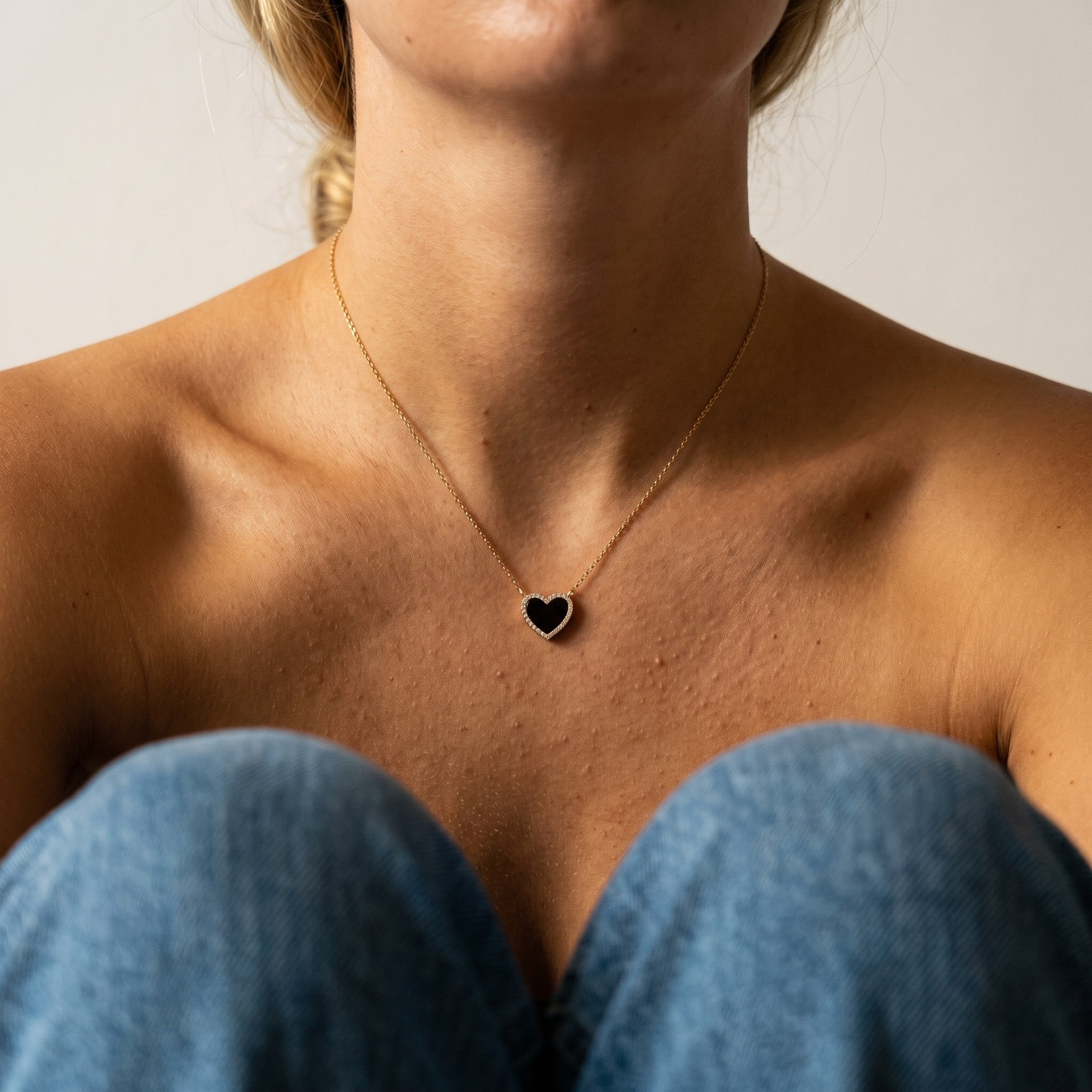 reveriebygemma black onyx heart pendant necklace with a cubic zirconia halo on a 14k gold plated sterling silver chain