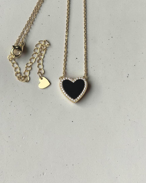 reveriebygemma black onyx heart pendant necklace with a cubic zirconia halo on a 14k gold plated sterling silver chain