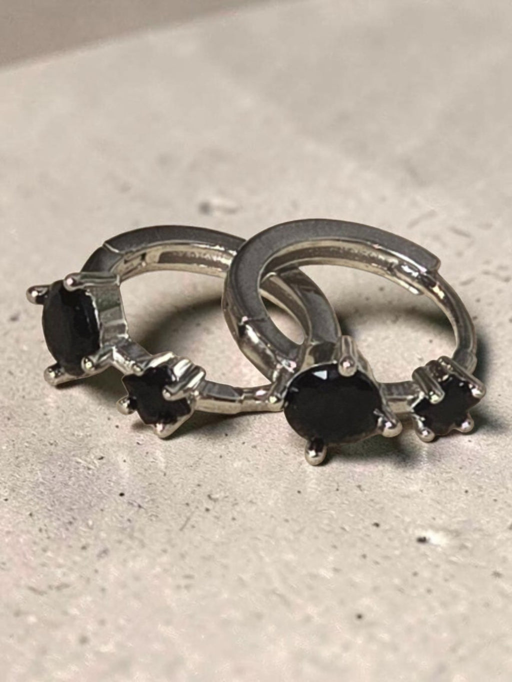 reveriebygemma sterling silver huggie hoops featuring two round-cut black onyx gemstones in a prong setting