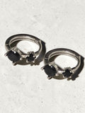 reveriebygemma sterling silver huggie hoops featuring two round-cut black onyx gemstones in a prong setting