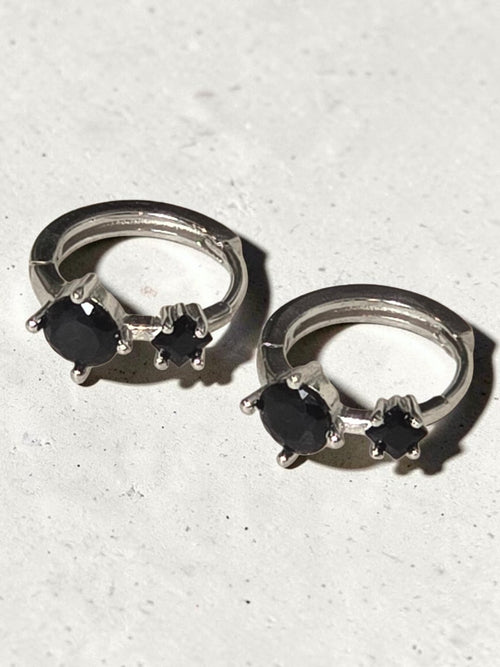reveriebygemma sterling silver huggie hoops featuring two round-cut black onyx gemstones in a prong setting