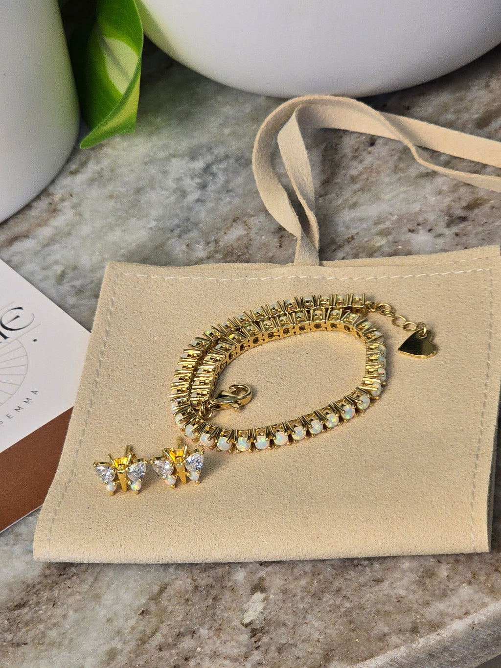 reveriebygemma butterfly stud earrings and matching opal tennis bracelet in 18kt gold vermeil on a velvet pouch