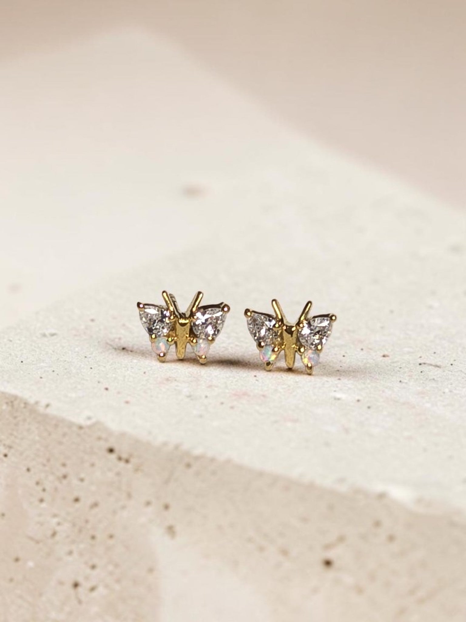 reveriebygemma butterfly stud earrings in 18kt gold vermeil with simulated diamonds and iridescent opal wings