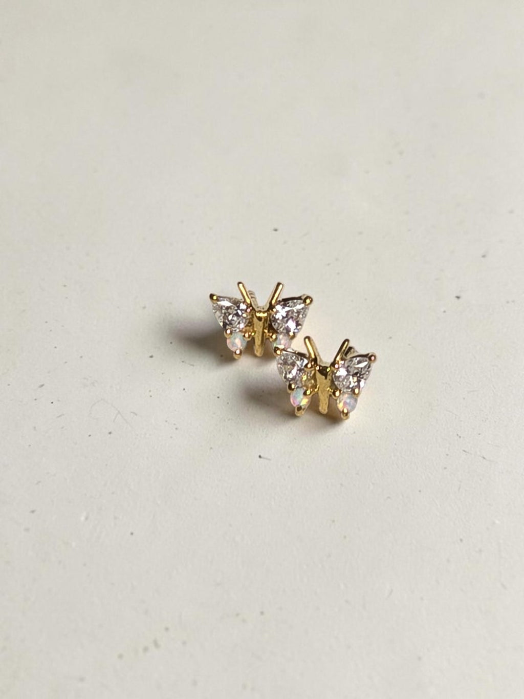reveriebygemma butterfly stud earrings in 18kt gold vermeil with simulated diamonds and iridescent opals