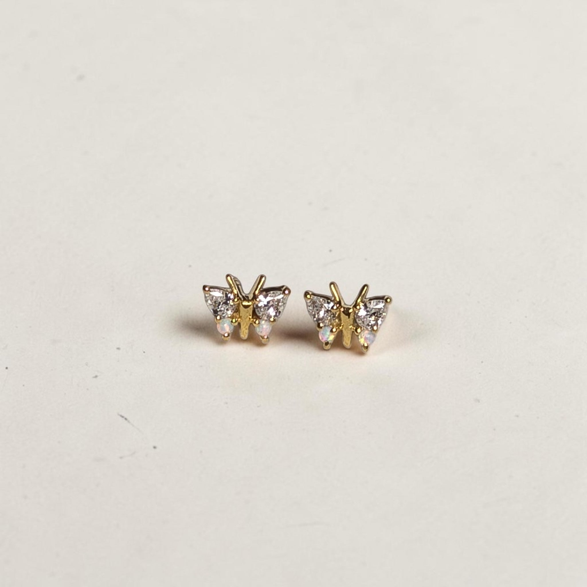 reveriebygemma butterfly stud earrings in 18kt gold vermeil with simulated diamonds and iridescent opals