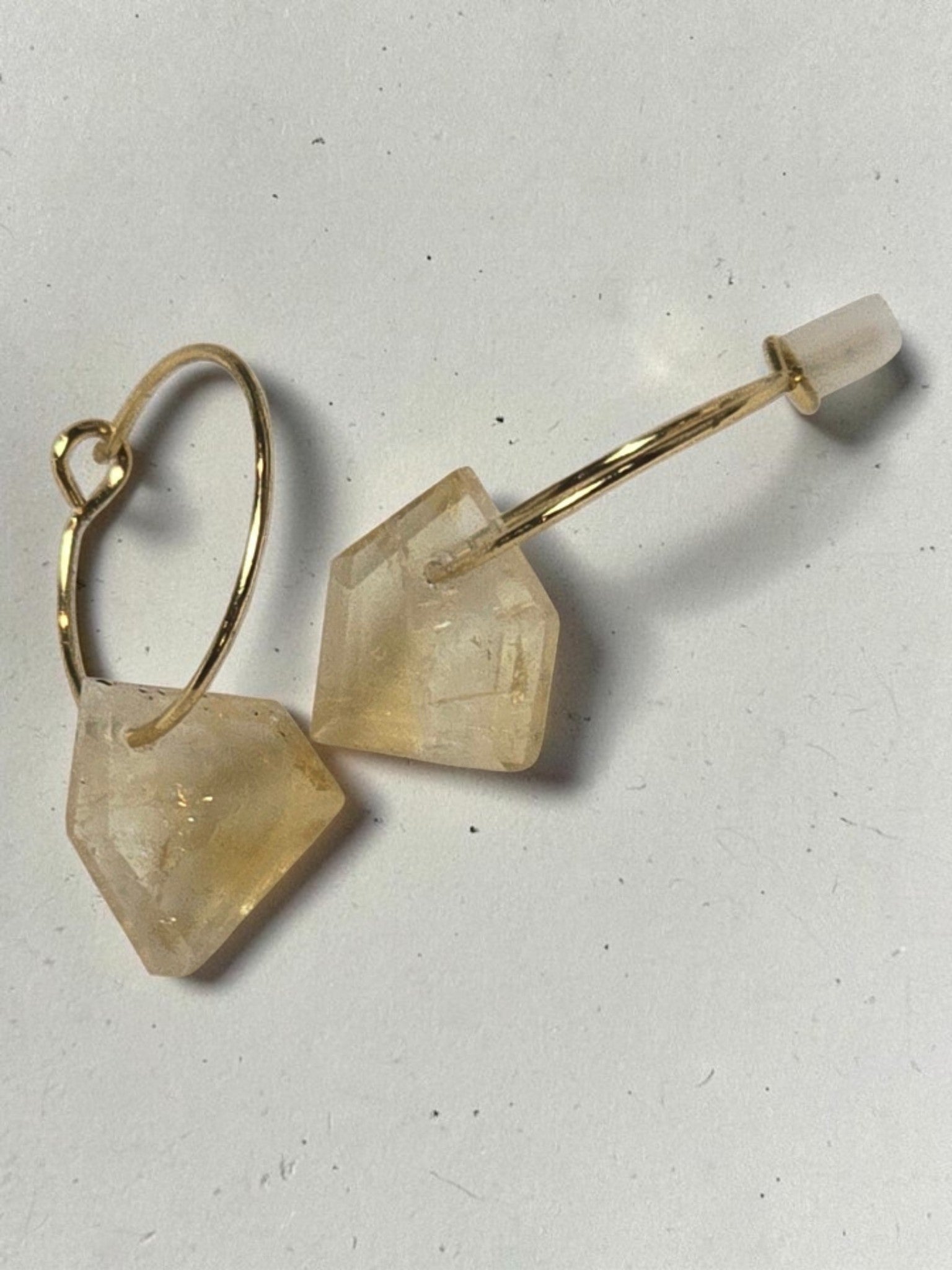 reveriebygemma gold-plated mini hoop earrings featuring translucent raw-cut geometric citrine gemstone drops.