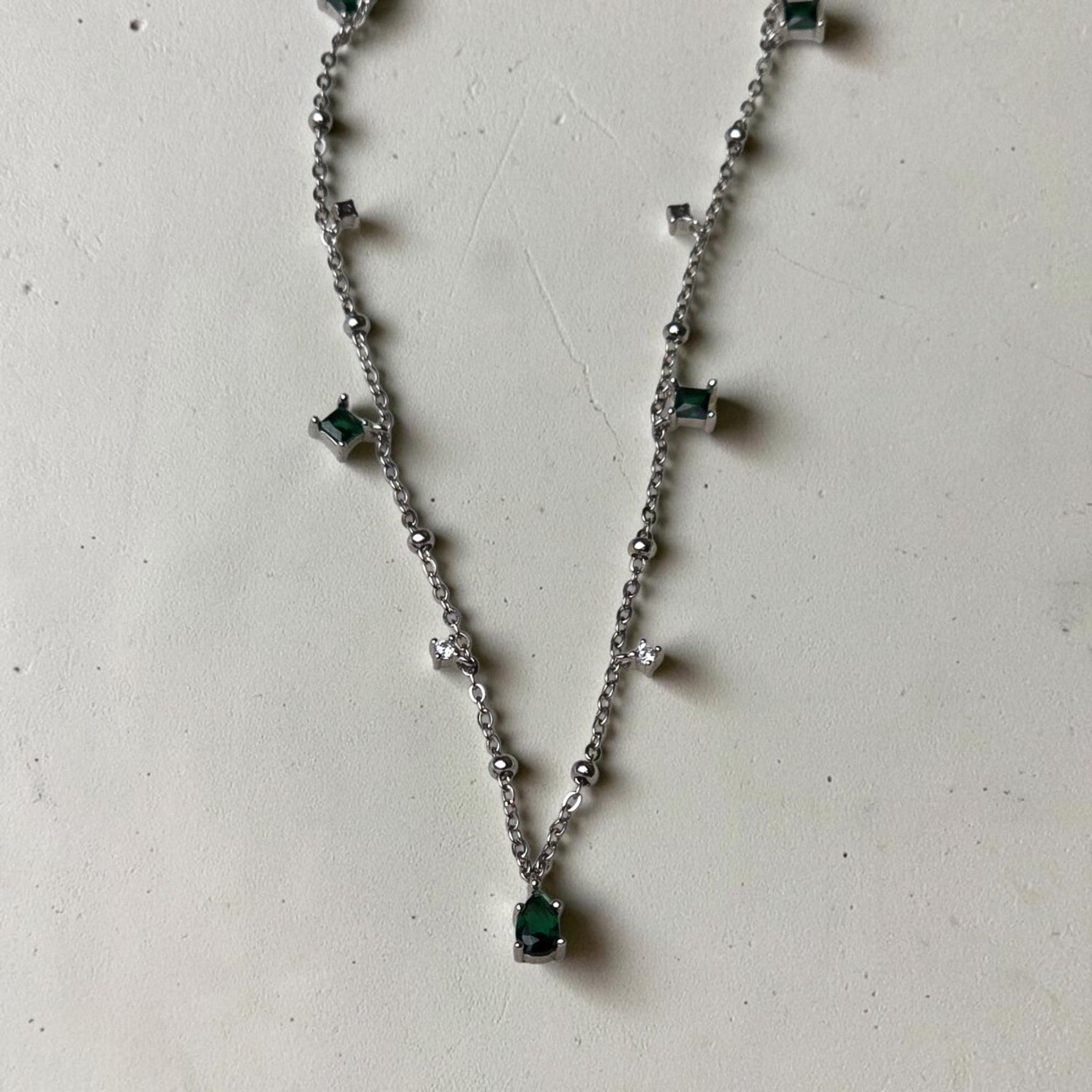 reveriebygemma sterling silver choker with pear-cut emerald pendant and alternating green emerald and CZ tassel charms
