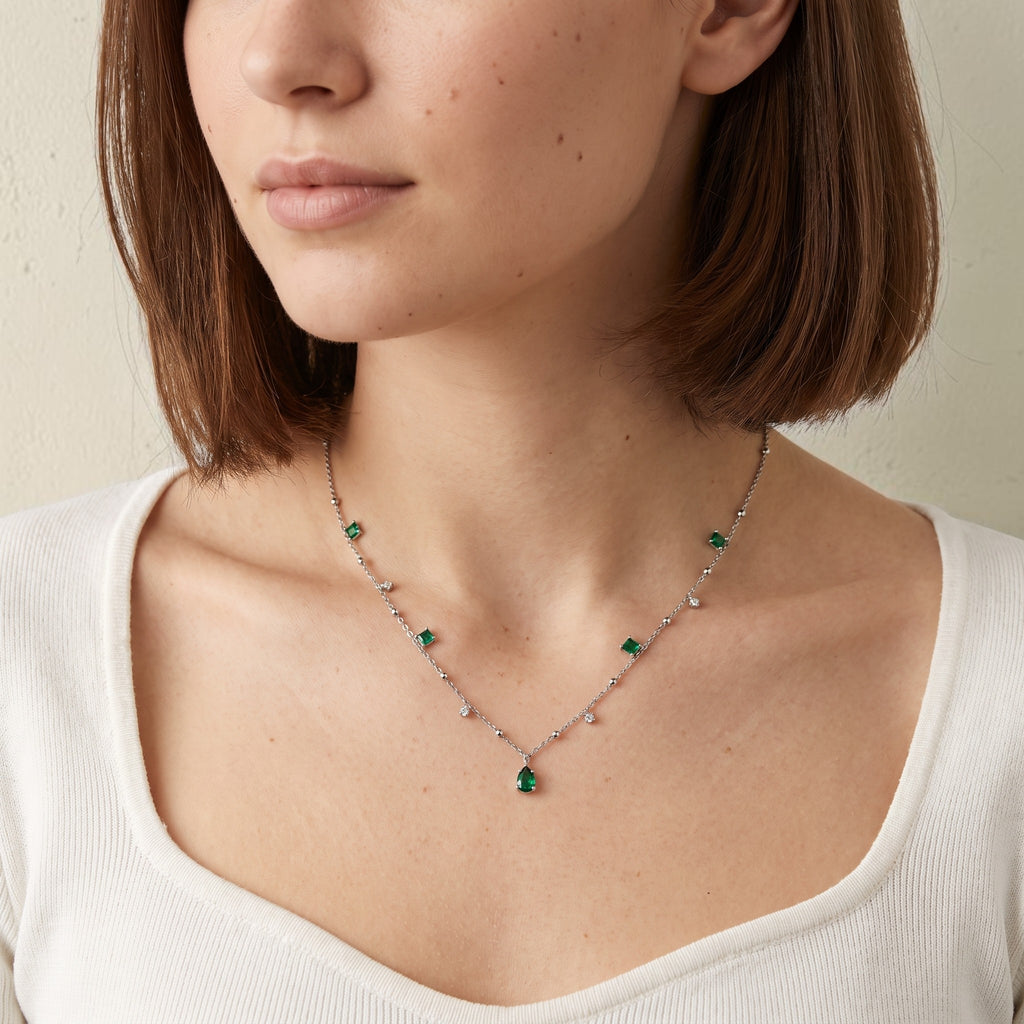 reveriebygemma sterling silver choker with emerald and cubic zirconia tassel charms worn on a model