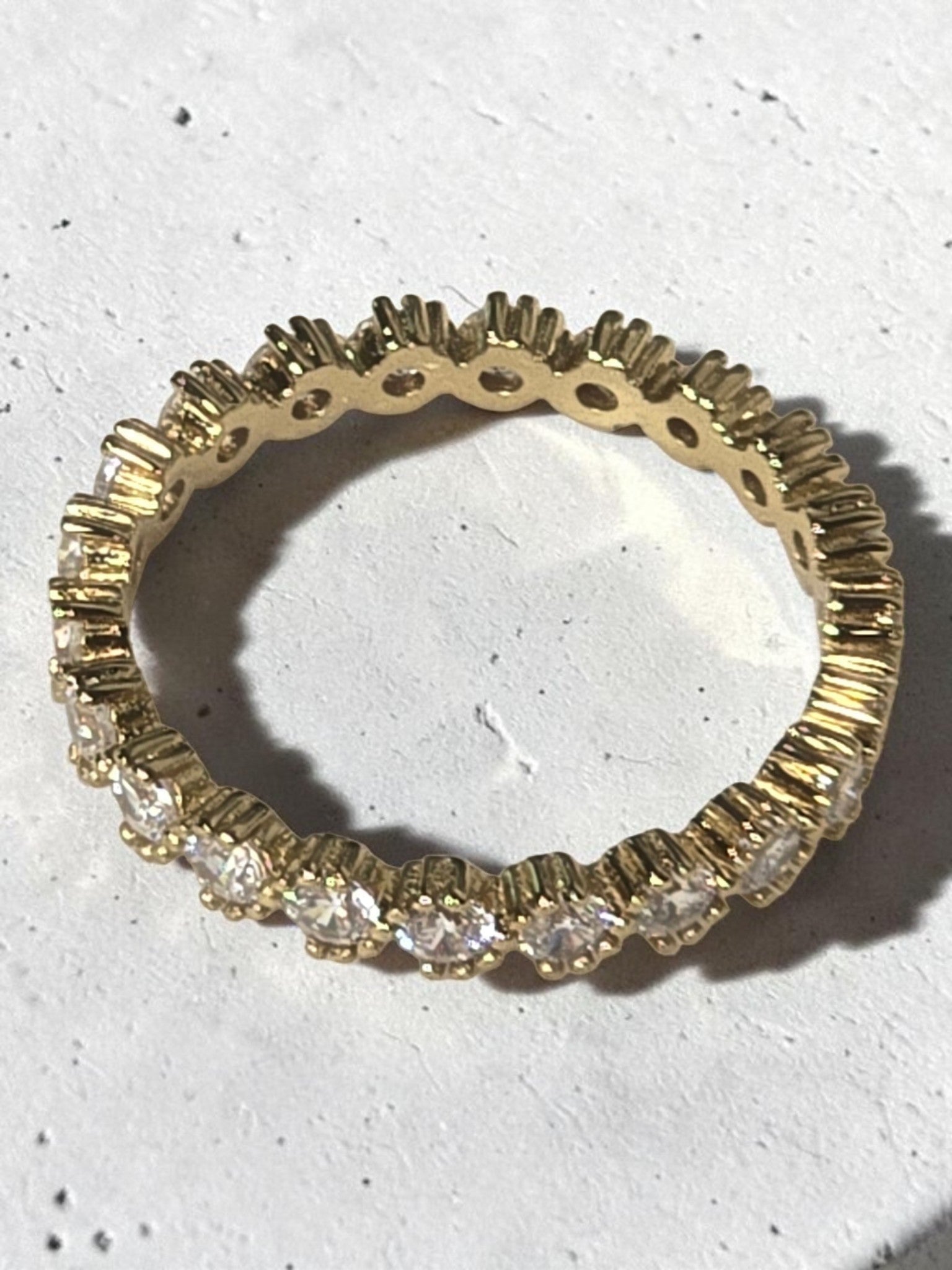 reveriebygemma 14kt gold plated sterling silver eternity band with bezel-set cubic zirconia stones and scalloped edges