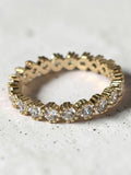 reveriebygemma 14kt gold plated sterling silver eternity band with bezel-set cubic zirconia and scalloped milgrain edges