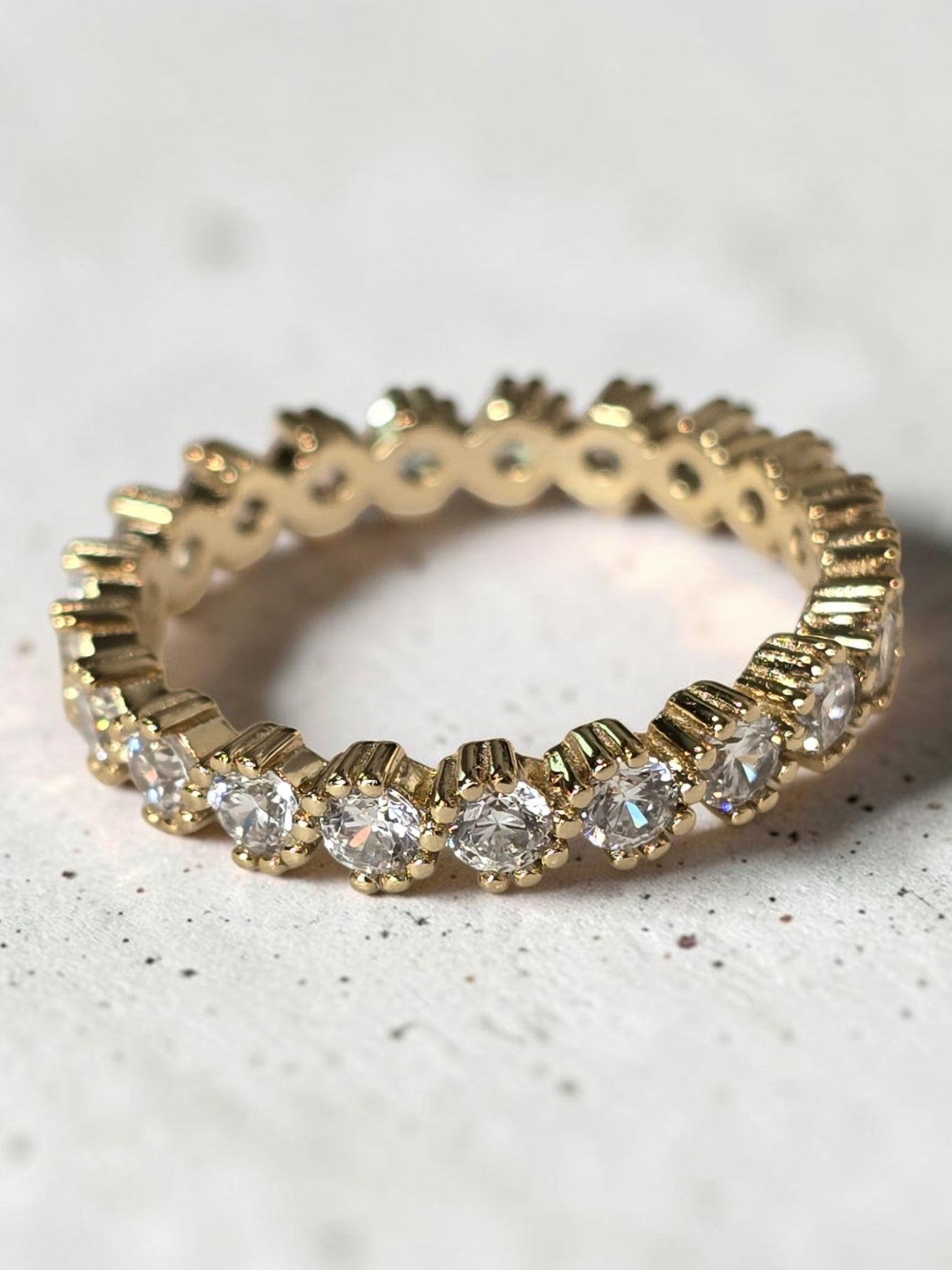 reveriebygemma 14kt gold plated sterling silver eternity band with bezel-set cubic zirconia and scalloped milgrain edges