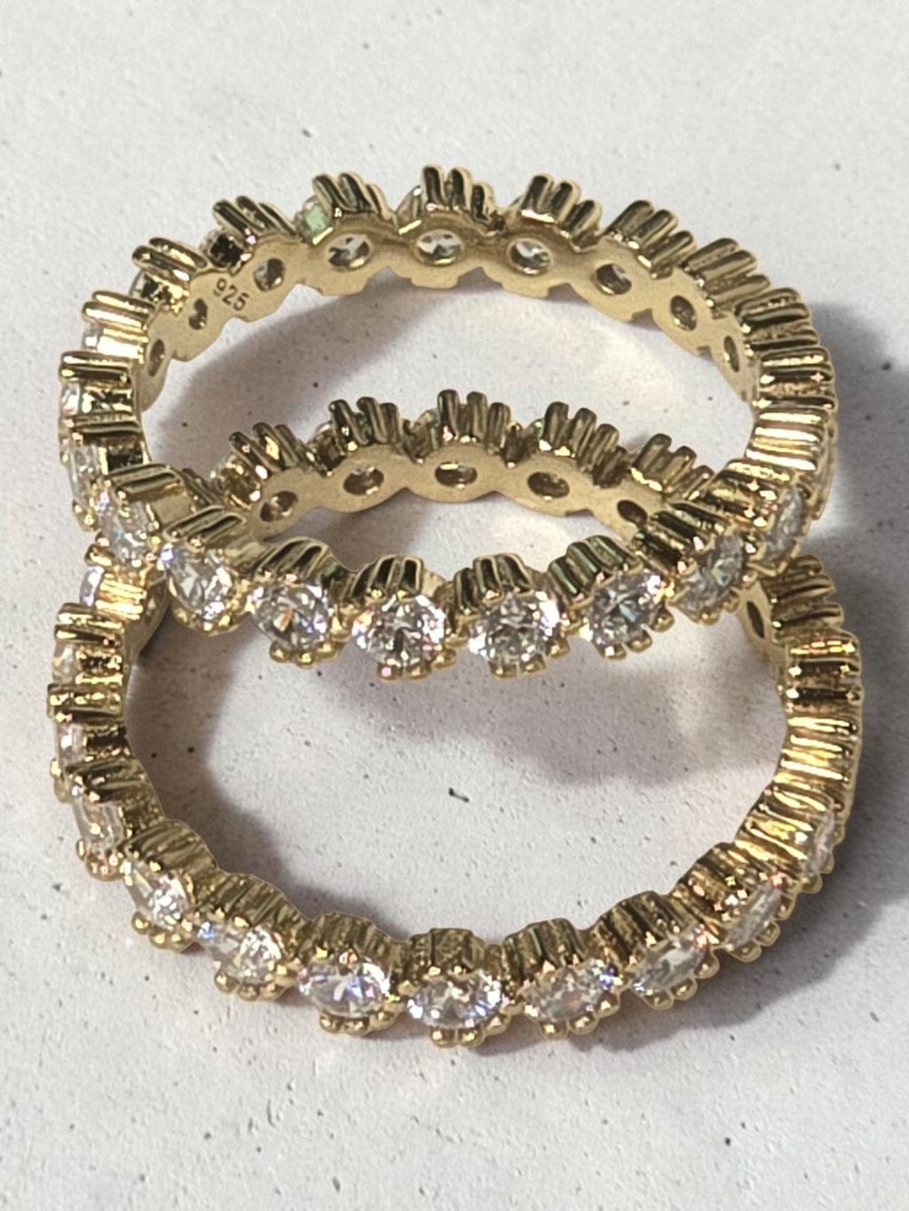 reveriebygemma 14kt gold plated sterling silver eternity band with bezel-set cubic zirconia stones and scalloped edges