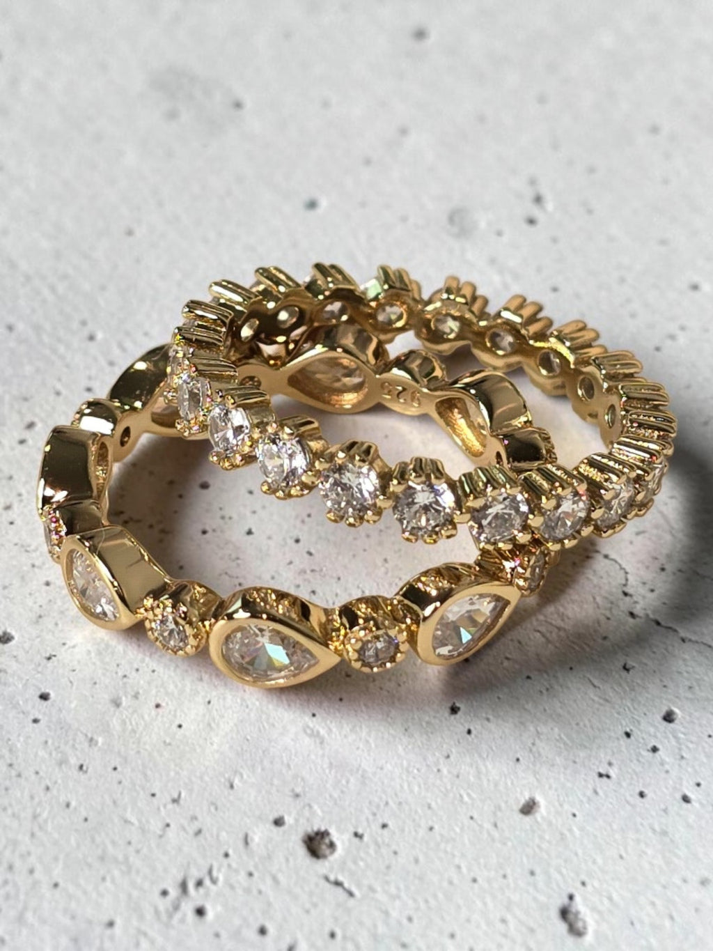 reveriebygemma gold plated sterling silver eternity stacking rings with bezel-set cubic zirconia and milgrain detail