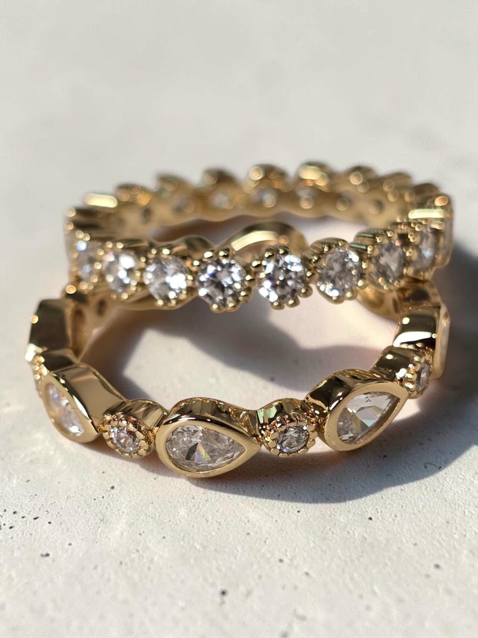 reveriebygemma gold plated sterling silver stacking ring with pear and round bezel set cubic zirconia stones