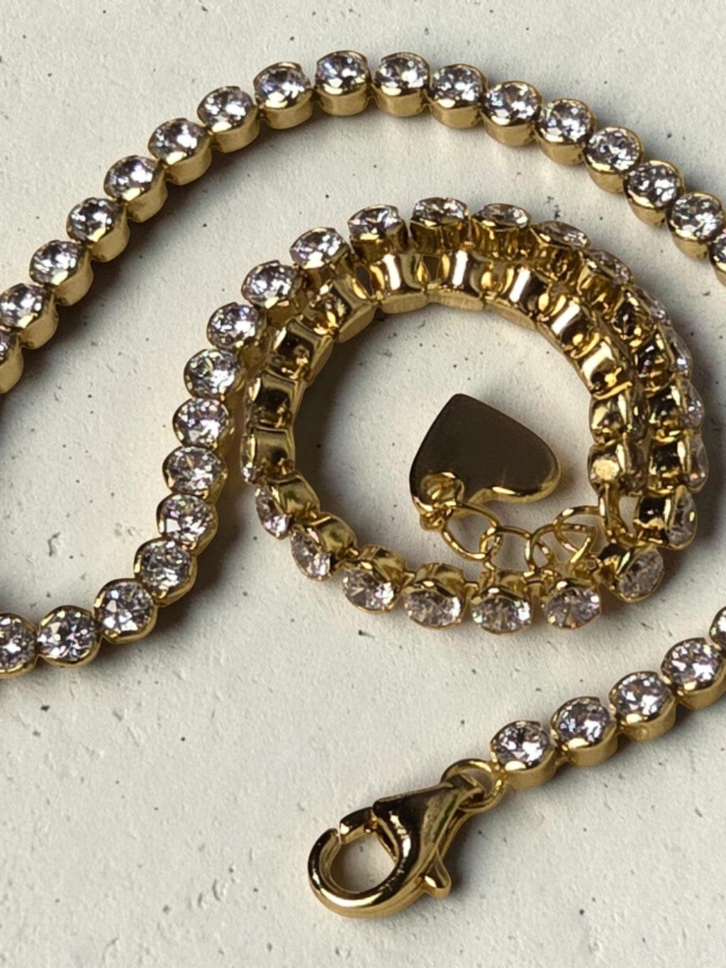 reveriebygemma 14kt gold plated sterling silver tennis anklet with round cubic zirconia stones and a heart charm
