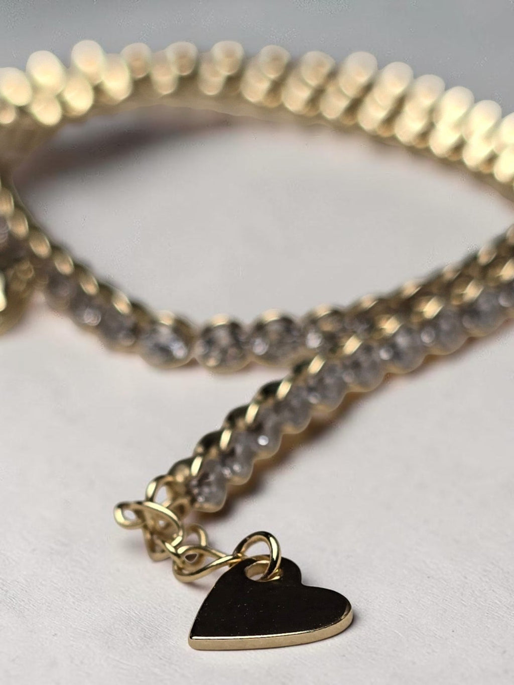 reveriebygemma 14kt gold plated sterling silver tennis anklet with round cubic zirconia stones and a heart charm