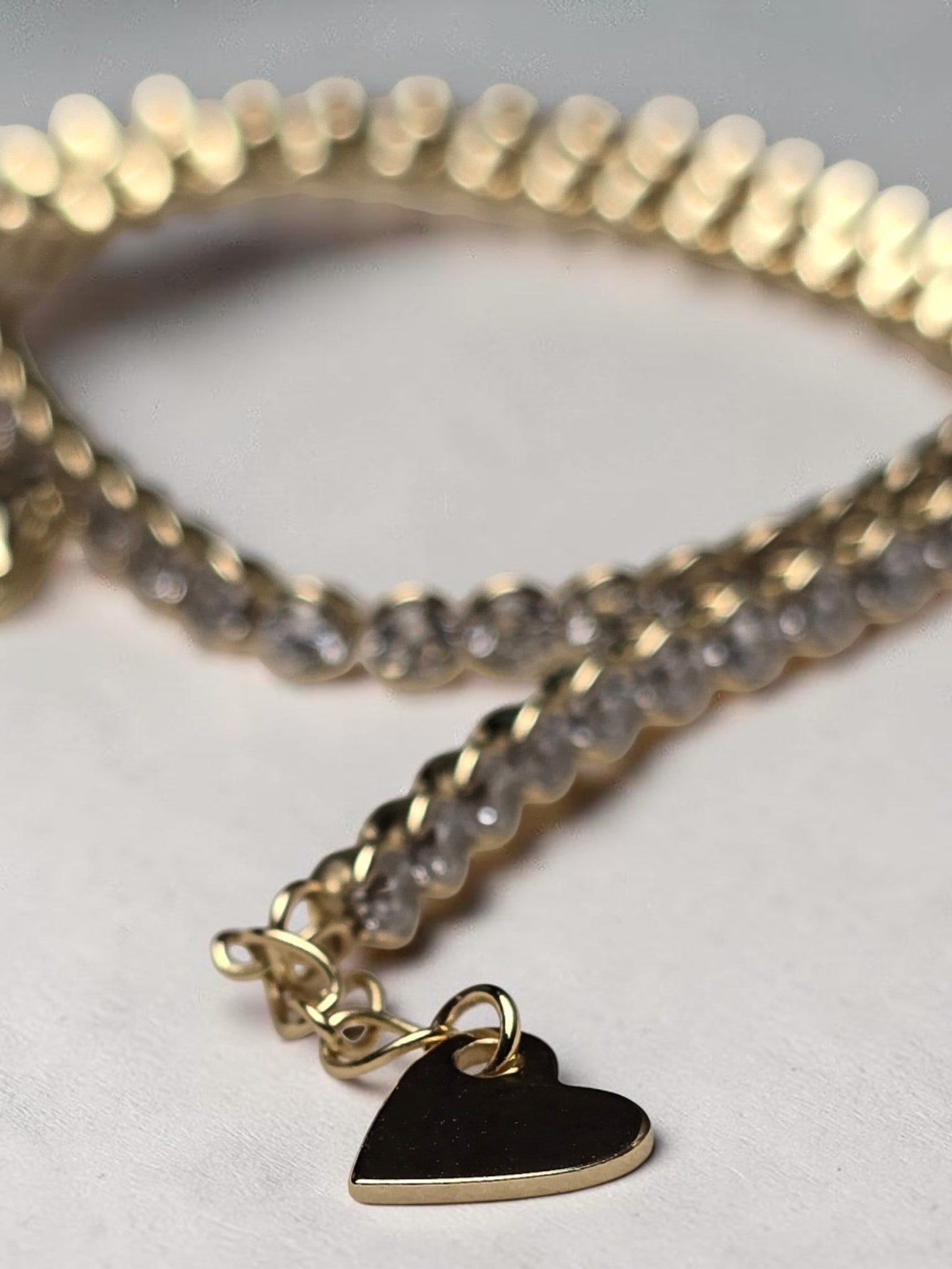 reveriebygemma 14kt gold plated sterling silver tennis anklet with round cubic zirconia stones and a heart charm