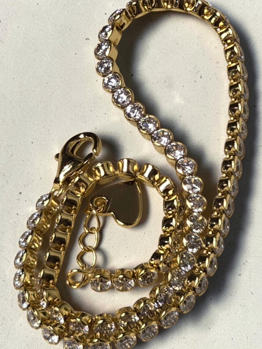 reveriebygemma gold plated sterling silver tennis anklet with cubic zirconia stones and a delicate heart charm