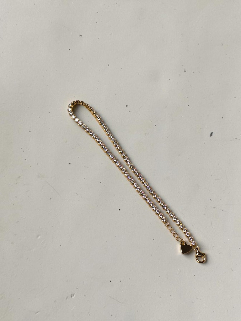 reveriebygemma 14kt gold plated sterling silver tennis anklet with cubic zirconia stones and a heart charm