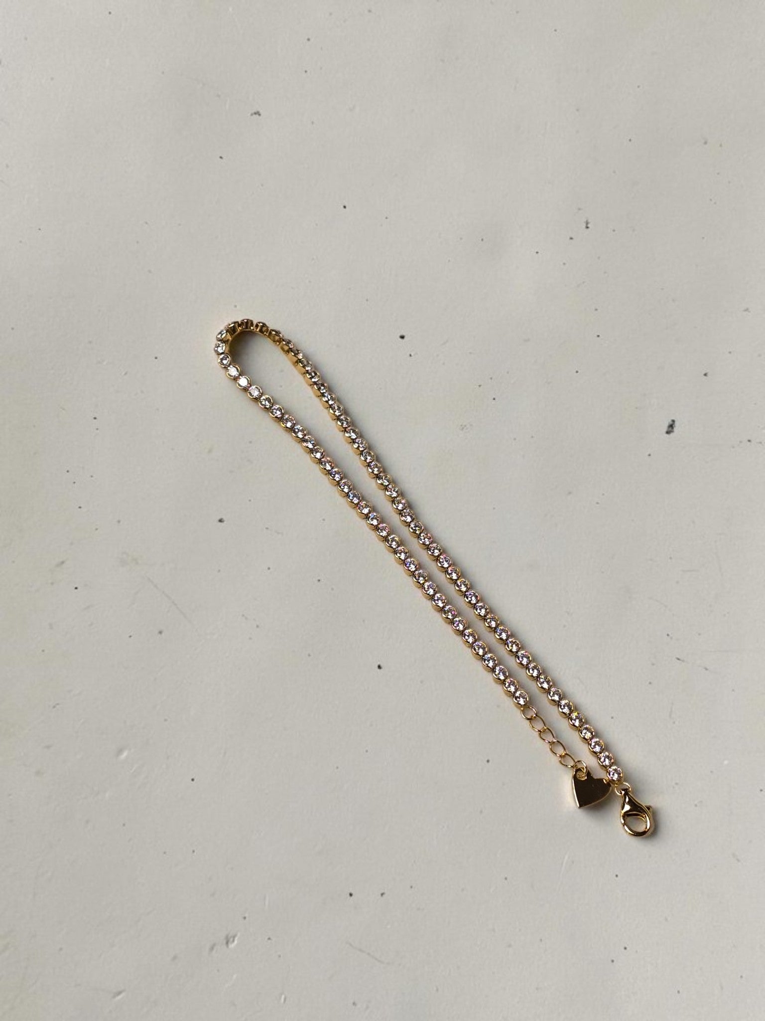 reveriebygemma 14kt gold plated sterling silver tennis anklet with cubic zirconia stones and a heart charm