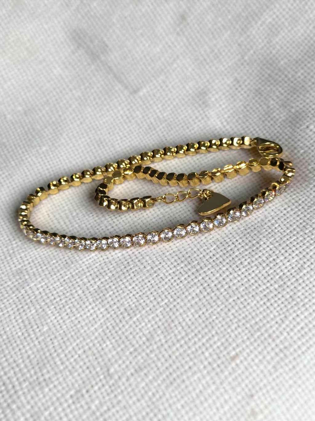 reveriebygemma 14kt gold plated sterling silver tennis anklet with round cubic zirconia stones and a heart charm