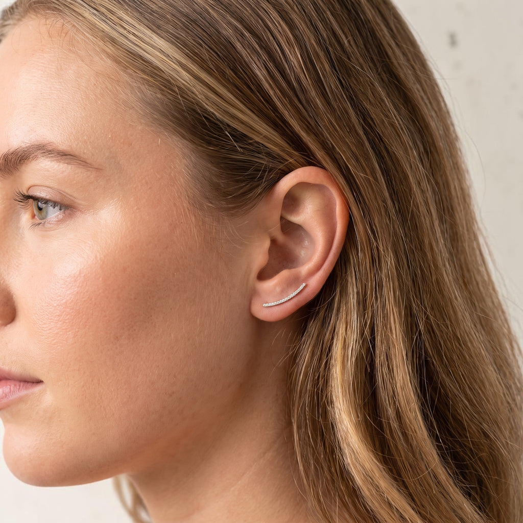 reveriebygemma dainty gold plated sterling silver ear climber with micro-pavé cubic zirconia worn on a woman's ear