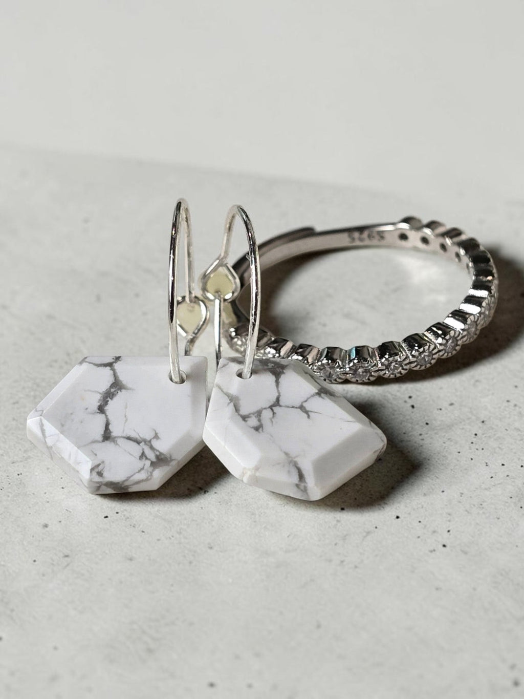 reveriebygemma geometric white howlite and sterling silver huggie earrings with a matching pavé stacking ring.