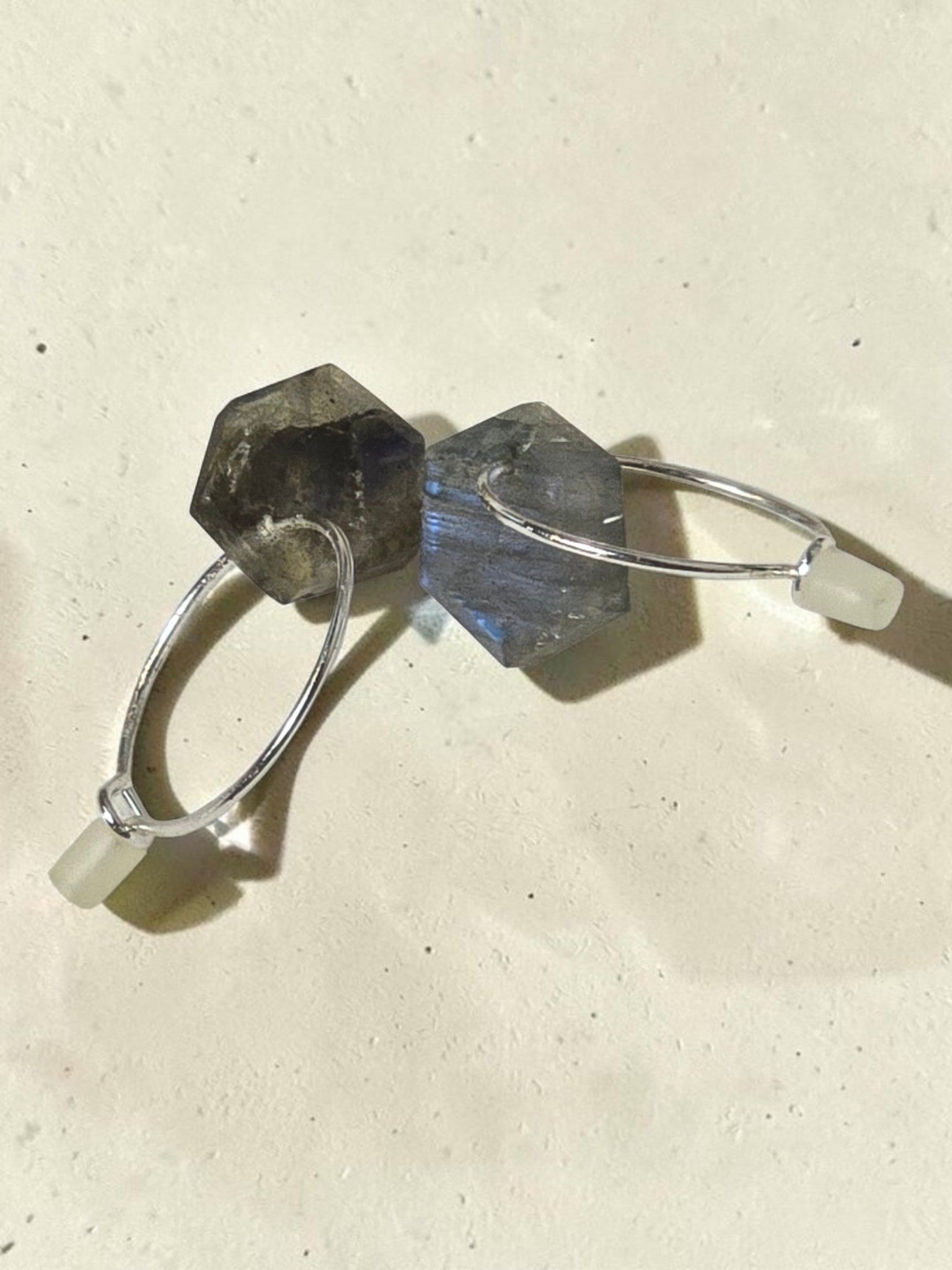 reveriebygemma sterling silver huggie earrings with geometric labradorite stone drops showing iridescent blue flash