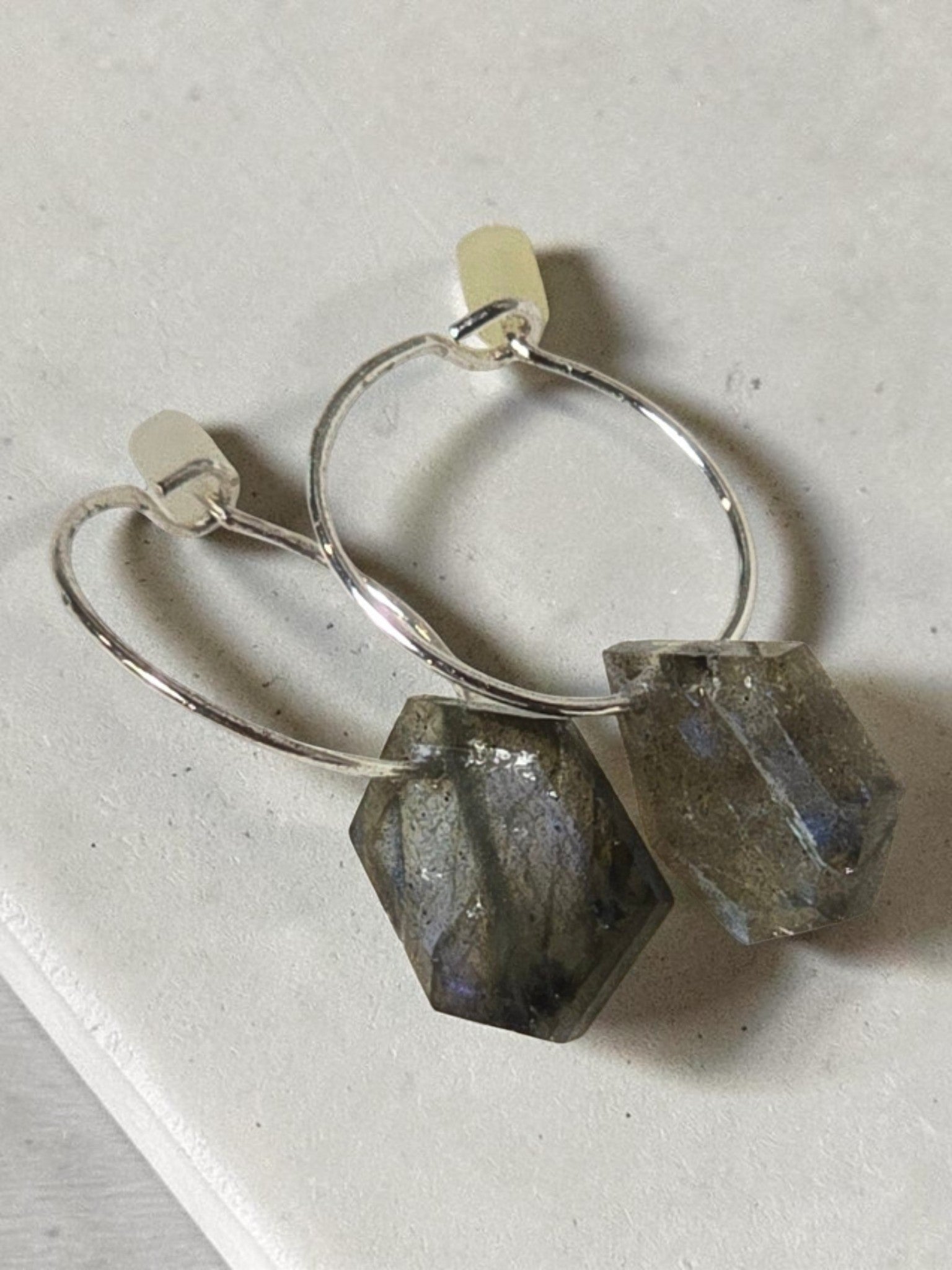 reveriebygemma sterling silver huggie earrings with geometric labradorite gemstone drops showing iridescent flashes