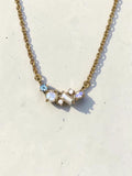 reveriebygemma 18kt gold vermeil necklace featuring an asymmetric cluster of rainbow moonstone, London blue, and white topaz.