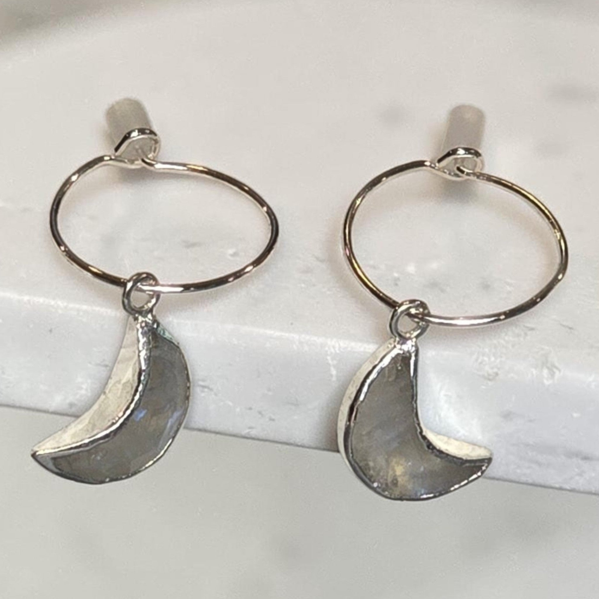 reveriebygemma celestial moonstone mini huggie hoops in 925 sterling silver with hand-carved crescent moon charms
