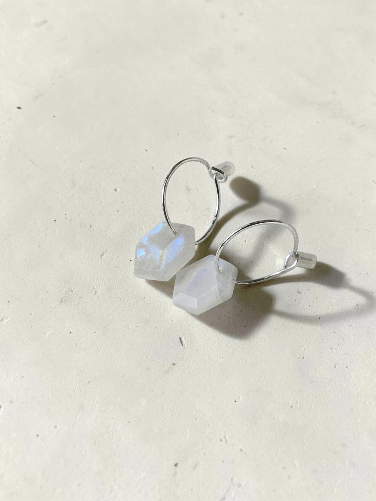 reveriebygemma 925 sterling silver huggie hoop earrings with geometric raw moonstone drops showing iridescent flash