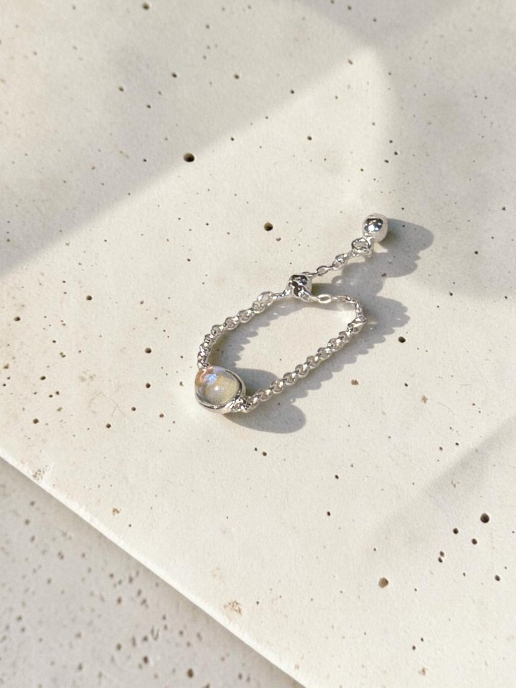 reveriebygemma adjustable 925 sterling silver chain ring featuring a luminous simulated moonstone cabochon