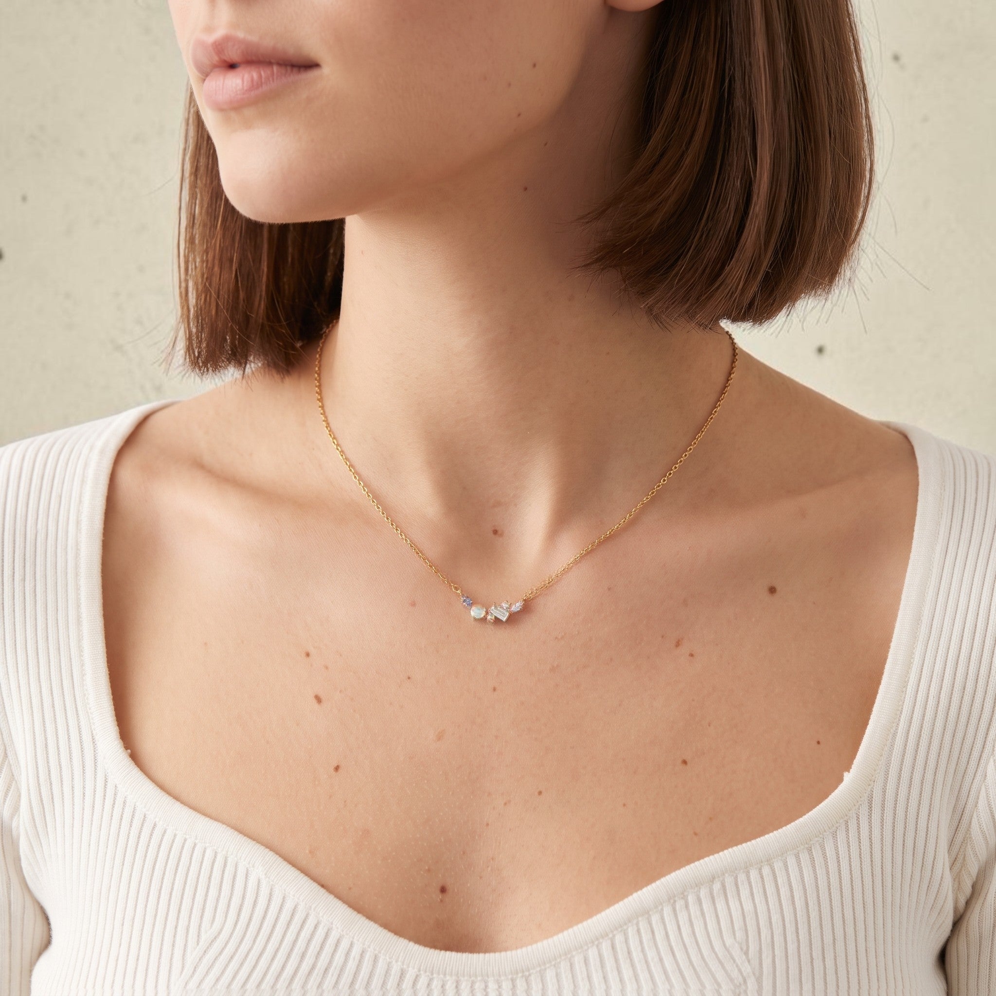 reveriebygemma celestial cluster necklace with rainbow moonstone, London blue topaz, and white topaz in gold vermeil.
