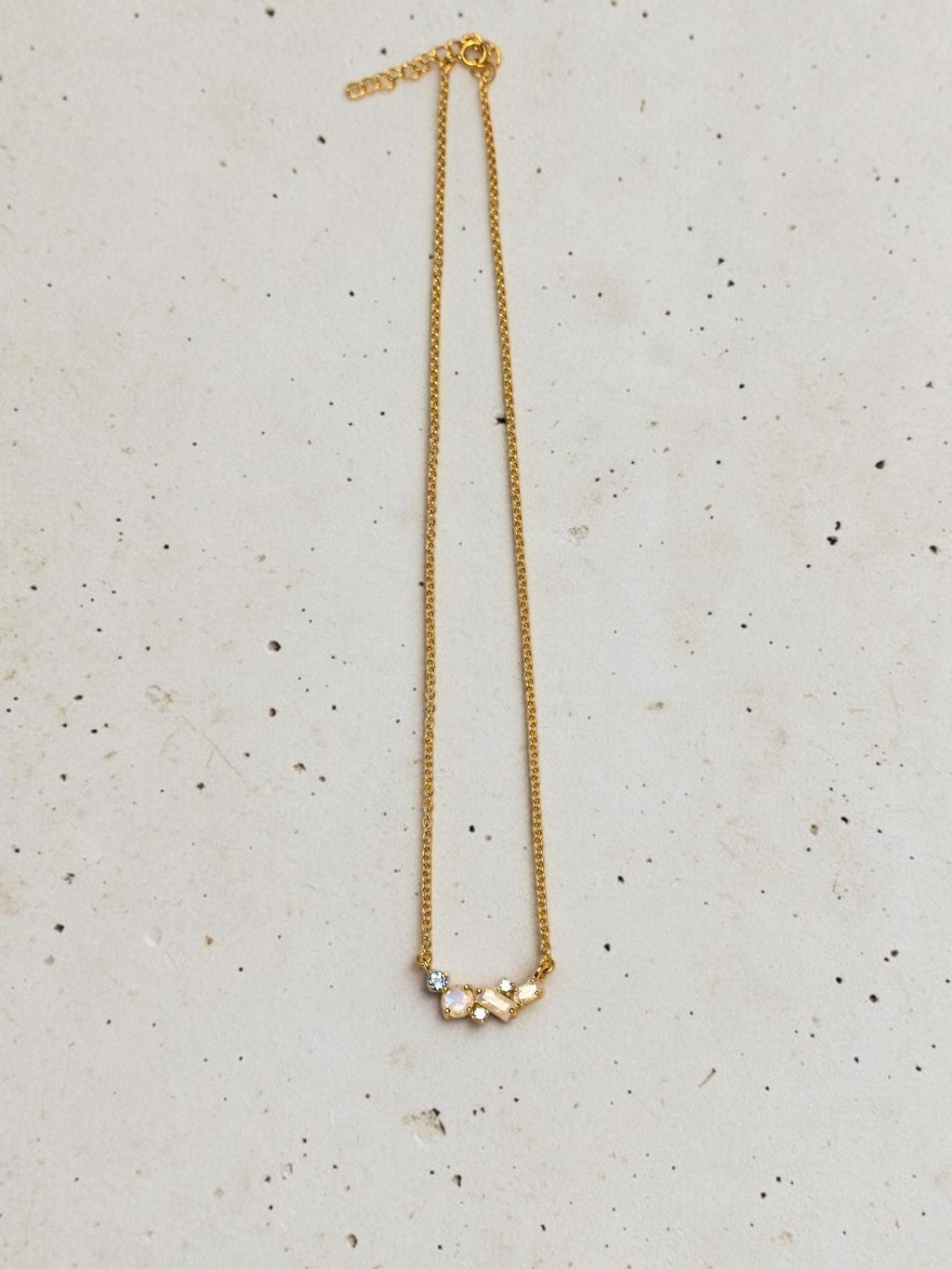 reveriebygemma celestial cluster necklace featuring rainbow moonstone, London blue topaz, and white topaz in gold vermeil