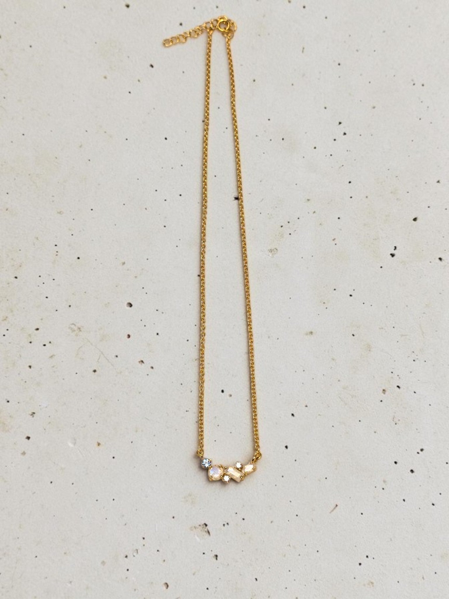 reveriebygemma celestial cluster necklace featuring rainbow moonstone, London blue topaz, and white topaz in gold vermeil