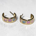 reveriebygemma 18kt gold vermeil hoop earrings featuring square-cut iridescent opal inlays in a colorful ombré pattern.