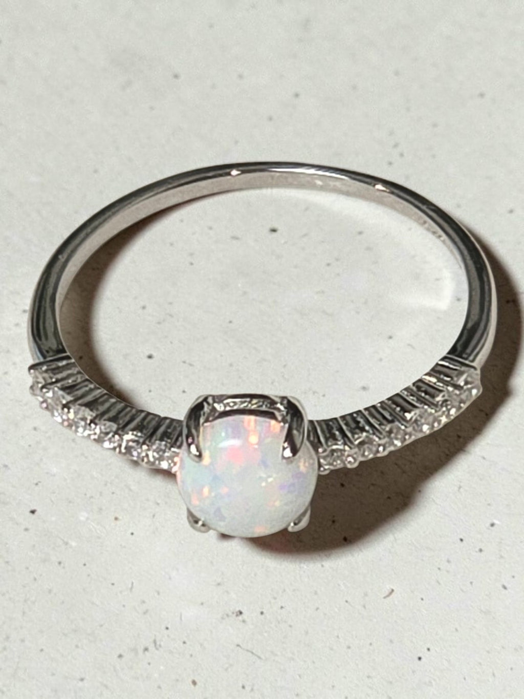 reveriebygemma sterling silver ring featuring a round lab-created opal with iridescent fire and pavé CZ accents